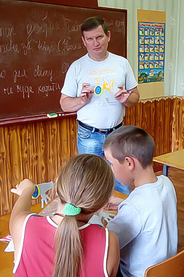 Sergei teaching children at Sunday school.