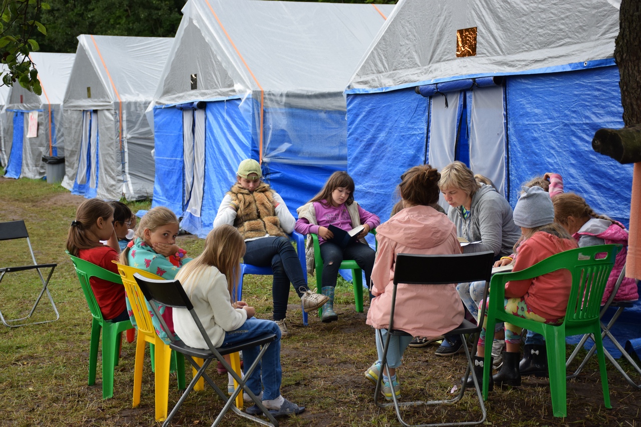 Camp workers lead the girls in a Bible study.