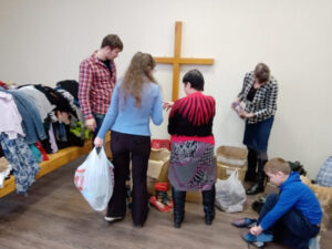 Giving clothing to families in need.