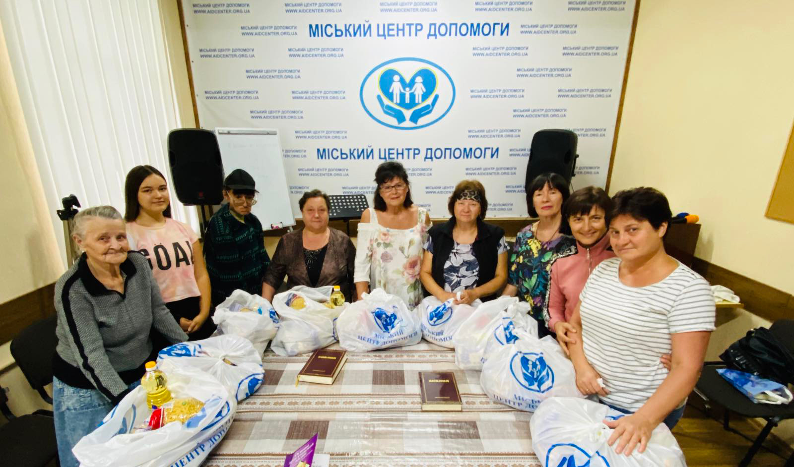 Liliya (middle, in white) and other ladies receive much-needed bags of aid.