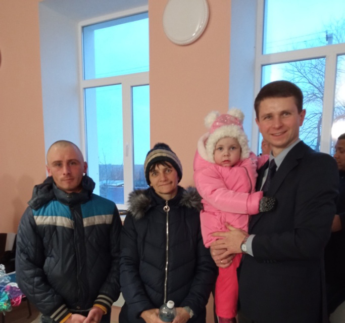 Pastor Andrei with Katerina and her family.