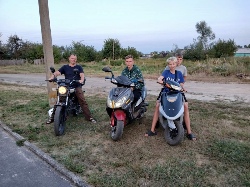 Boys with their motorcycles.