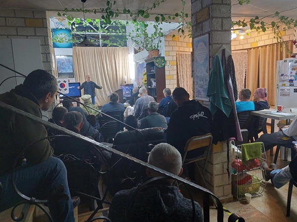People gathered indoors discussing the true Messiah