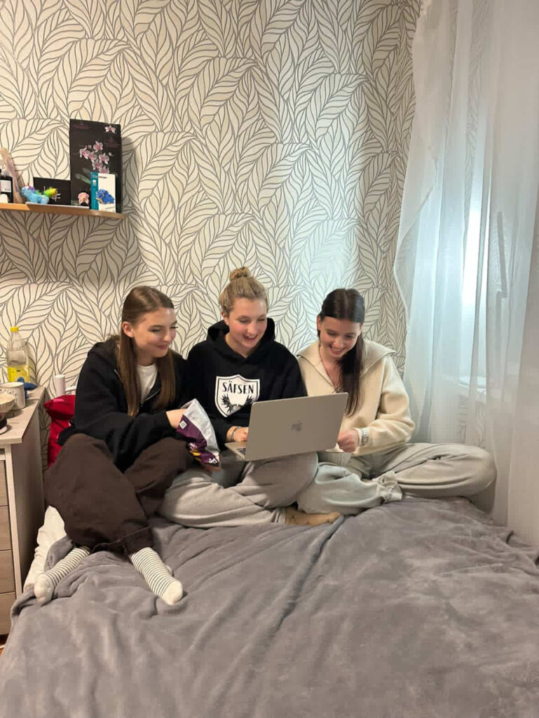 Orphan graduates with a new laptop.