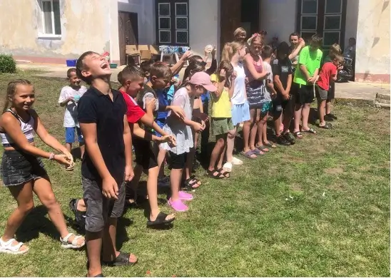 Kids standing in line and smiling