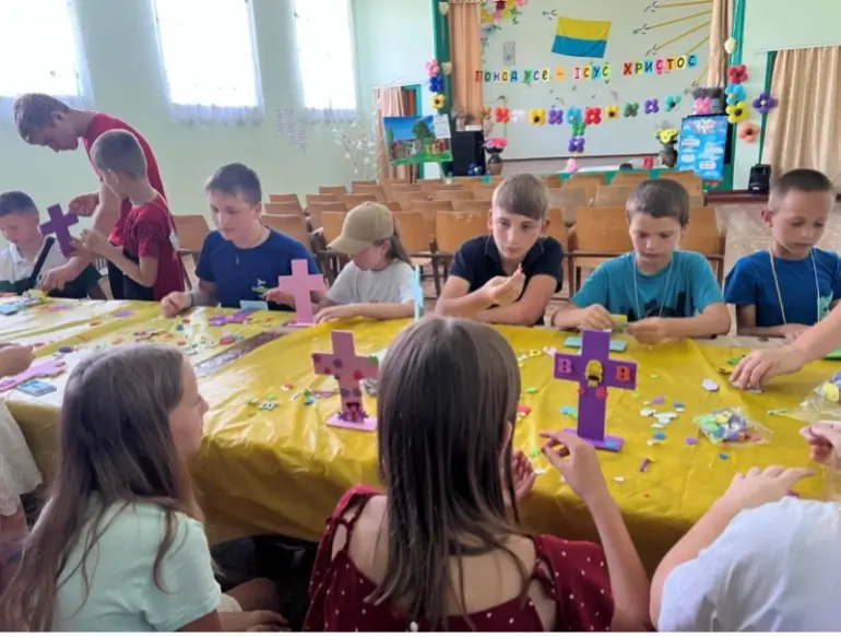 Kids looking at a cross