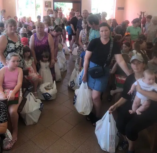 Women holding bags of essentials