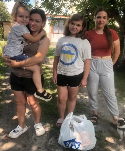 Baby, woman, girl, and teen posing for a photo