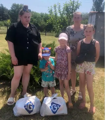Family posing with SGA aid bags