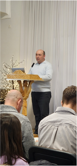 Pastor Oleg preaches.